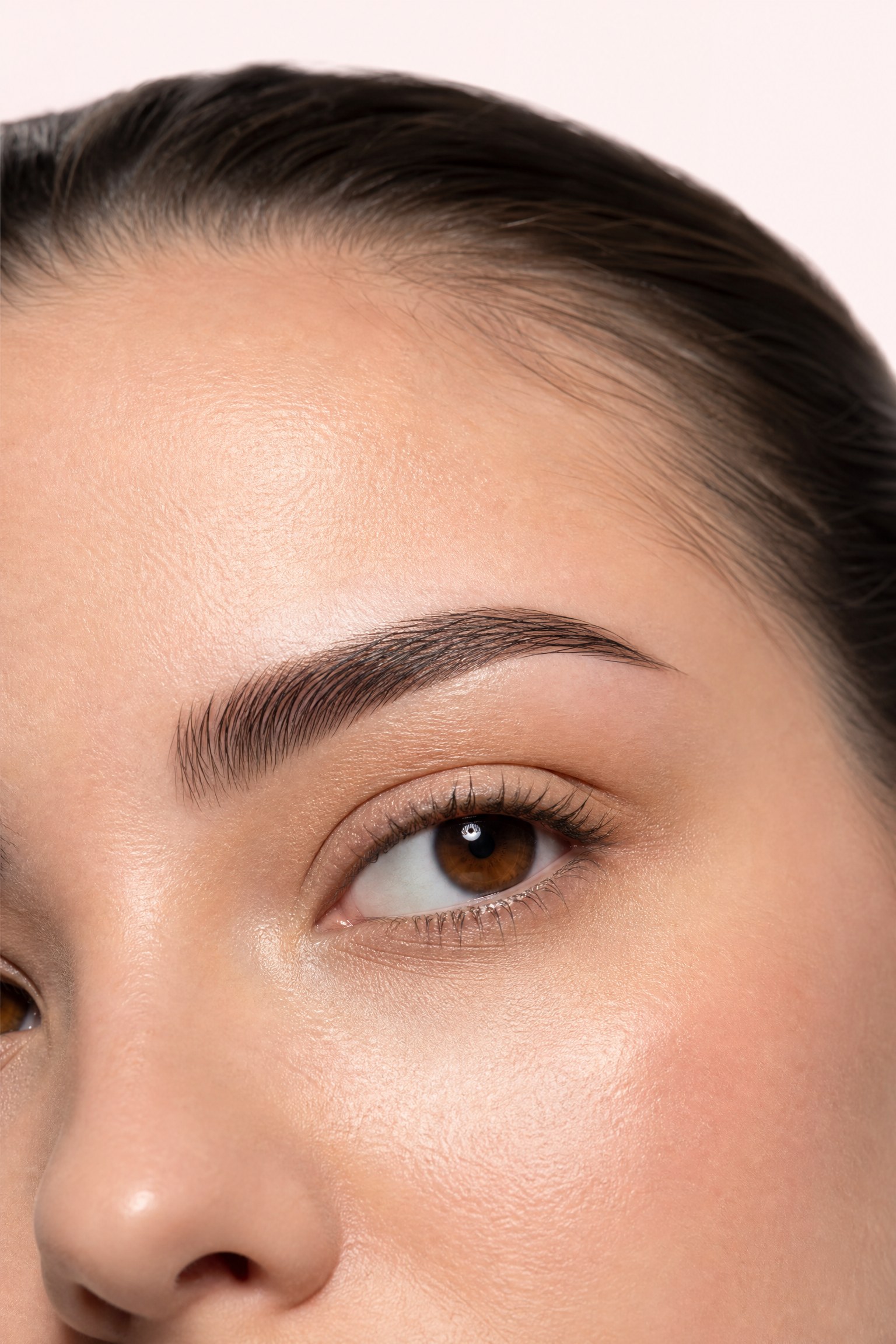 Close-up portrait of a woman’s brow and upper-eye area — the region affected by heavy brows and hooded eyes, treated at Facial Sculpting London