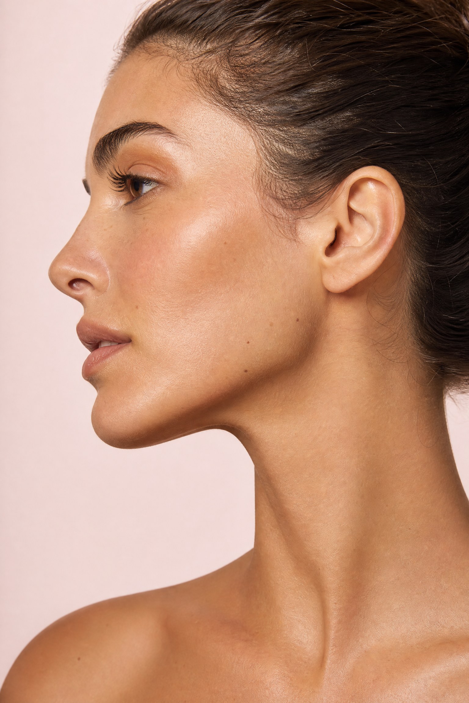 Close-up profile portrait of a woman showing a defined jawline and the jaw-to-neck angle — the key areas for jawline definition and jowl treatments at Facial Sculpting London